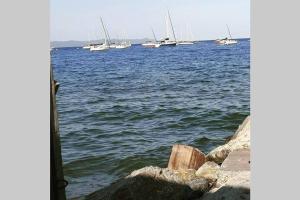 a group of boats in the water with rocks at Appartement avec Jardin privatif centre ville in Hyères