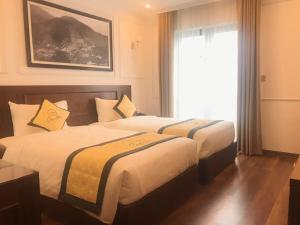 Säng eller sängar i ett rum på Camellia Luxury Hotel Tam Đảo