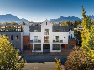 an aerial view of a house with mountains in the background at Hotel Krige in Stellenbosch