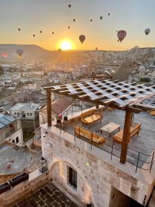 a view of a city with hot air balloons in the sky at Luvi Cave Hotel in Göreme