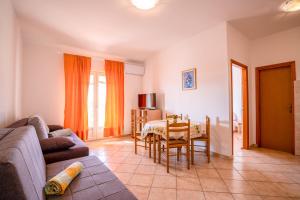a living room with a couch and a table at Apartments Valentin in Privlaka