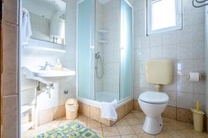 a bathroom with a toilet and a sink and a shower at Apartments Valentin in Privlaka +45 photos