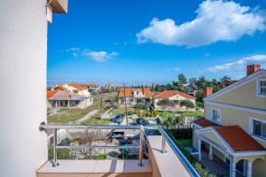 a balcony with a view of a neighborhood at Apartments Valentin in Privlaka