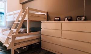 a bunk bed in a room with a ladder at Casa MaTi in Blankenberge