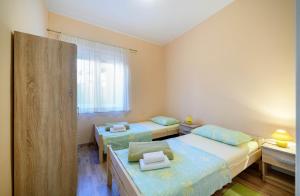 Zimmer mit 2 Betten und einem Fenster in der Unterkunft Urban City Center in Šibenik