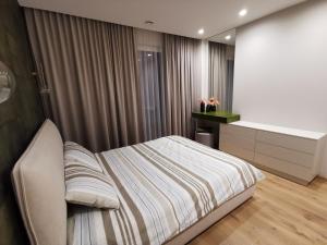 a bedroom with a bed and a bath tub at MyCasa CBD in Vilnius