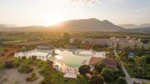 an aerial view of the resort with mountains in the background at Club Hotel Marina Beach in Orosei