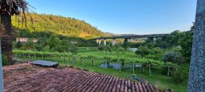 a view of a bridge over a river with a garden at A Taberna de Gundián in Vedra