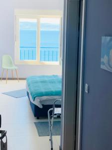 a bedroom with a bed and a window and a chair at Hotel Elu Iris in Split