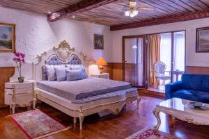 a bedroom with a king sized bed and a blue chair at Hansa Hotel in Tartu