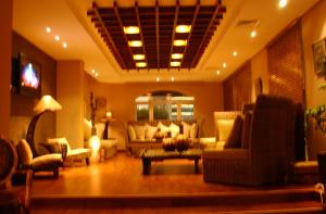 a living room with couches and chairs and a table at Spice Hotel in Kuwait +12 photos