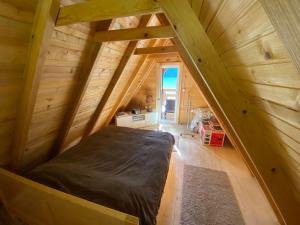 a bed in the middle of a room in a tree house at STARA PRUGA JAZ in Višegrad