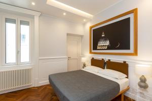 - une chambre avec un lit et une télévision murale dans l'établissement Amazing Vittoriano, à Rome