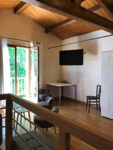 a living room with a flat screen tv on the wall at gîte de Fontjalabert en campagne tout confort in Lisle-sur-Tarn