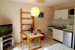 a kitchen with a table and a small kitchen with a tableablish at Hôtel**résidence BEAR in Port-Vendres