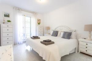Łóżko lub łóżka w pokoju w obiekcie Señorío de Aloha Apartahotel