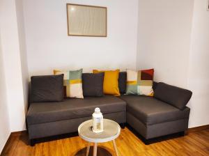 a living room with a couch and a table at Apartament Piaskowy NR A5 (3-5 os.) in Rowy