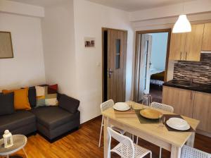 a living room with a table and a couch at Apartament Piaskowy NR A5 (3-5 os.) in Rowy