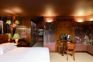 a bedroom with a bed and a desk with a microwave at Boundary Shoreditch in London