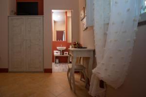 a bathroom with a sink and a table with a chair at Vecchio Granaio in Pisa