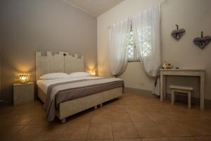 a bedroom with a large bed and a window at Vecchio Granaio in Pisa
