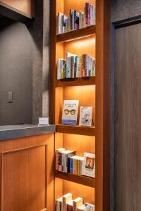 a book shelf filled with books in a room at hotel aima in Tokyo