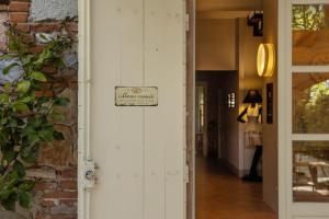 a hallway with a sign on the door of a store at Vecchio Granaio in Pisa