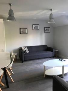 a living room with a black couch and a table at York - The Burton Stone - with parking in York