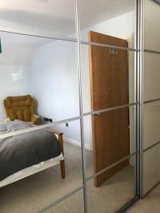 a bedroom with a bed and a glass closet at York - The Burton Stone - with parking in York