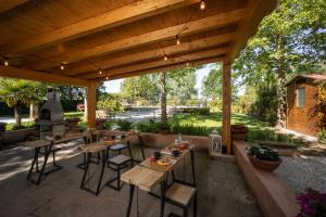 a patio with tables and chairs under a wooden pergola at Vecchio Granaio in Pisa