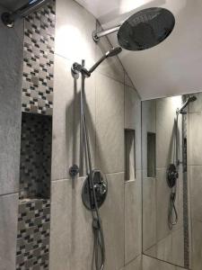 a bathroom with a shower with a shower head at York - The Burton Stone - with parking in York
