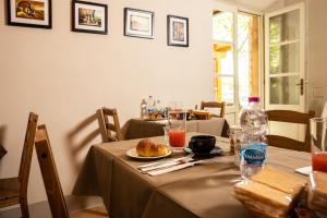a table with a plate of food and a bottle of water at Vecchio Granaio in Pisa