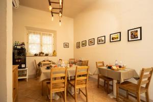 a dining room with two tables and chairs and a table and chairsktop at Vecchio Granaio in Pisa