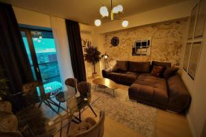 a living room with a couch and a glass table at Prime location, Sea view flat near the Beach in Constanţa