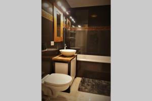 a bathroom with a toilet and a sink at Prime location, Sea view flat near the Beach in Constanţa