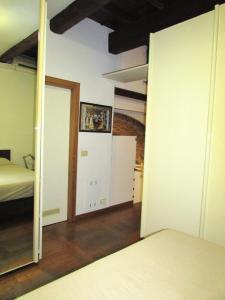 a bedroom with a bed and a mirror at ARIOSTEA Ap.1 in Ferrara