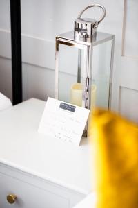 a lamp sitting on a table with a piece of paper at The Old Store Guest House in Chichester +26 photos
