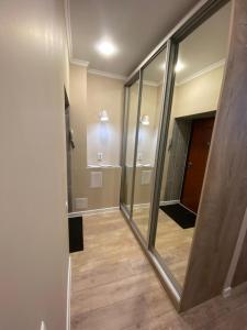 a room with mirrors and a hallway with a door at Люкс исы байзакова 133 in Pavlodar +8 photos