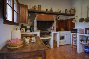 a kitchen with a table and a large oven at Son Canta by Villas Tramuntana in Caimari