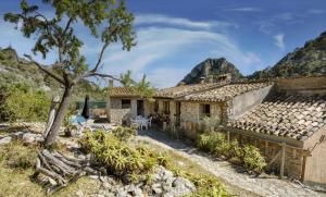 a stone house with a view of the mountains at Son Canta by Villas Tramuntana in Caimari