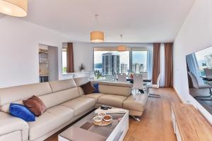 a living room with a couch and a table at Lux Panorama in Budva