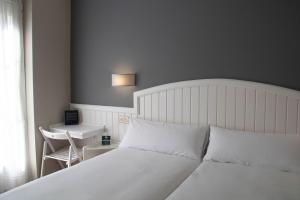 Ένα ή περισσότερα κρεβάτια σε δωμάτιο στο Alda Miramar Rooms