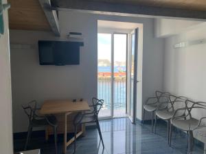 a dining room with chairs and a table and a window at Agenzia Isotur PESCATORI in Ponza +12 photos