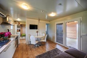 a kitchen and living room with a table and chairs at VINEA PANONIKA wine & mind retreat in Radenci