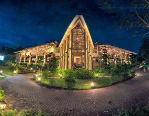 a large building with lights in front of it at Club Mahindra Virajpet, Coorg in Virajpet