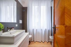 a bathroom with a white sink and a toilet at San Marco Boutique by Wonderful Italy in Venice