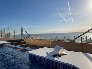 a swimming pool with a book sitting on a table at Hotel Las Vegas in Salou