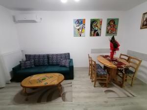 a living room with a couch and a table at Apartman Sofija in Banja Koviljača