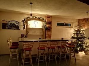 a kitchen with a christmas tree and a bar with stools at Damhills Apartments in Bronowko