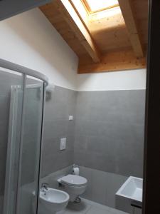 a bathroom with a toilet and a shower and a sink at Casa Magosta in Malcesine +12 photos